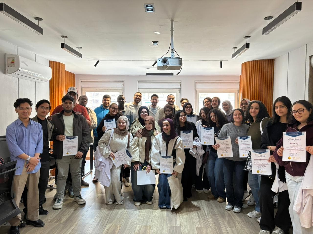 NXTMED students holding certificates after a hands-on workshop